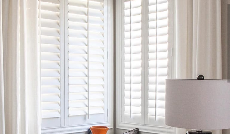 Plantation shutters in a corner window.